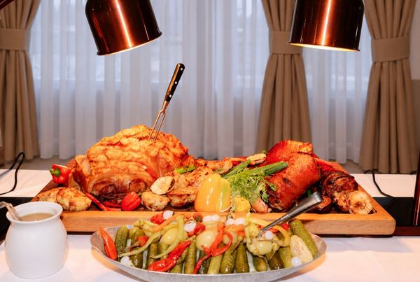 Roast meat on a board with pickled vegetables