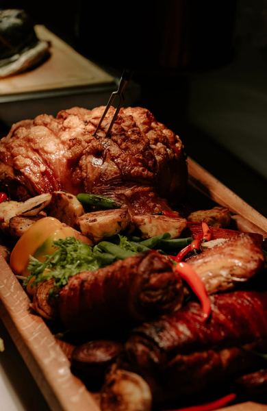 Roast meat and vegetables on a wooden board