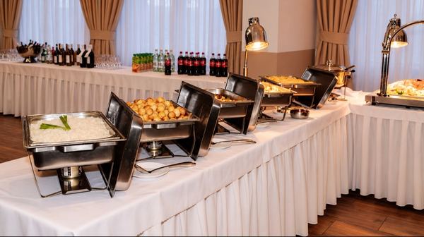 Row of chafing dishes with side dishes on the buffet
