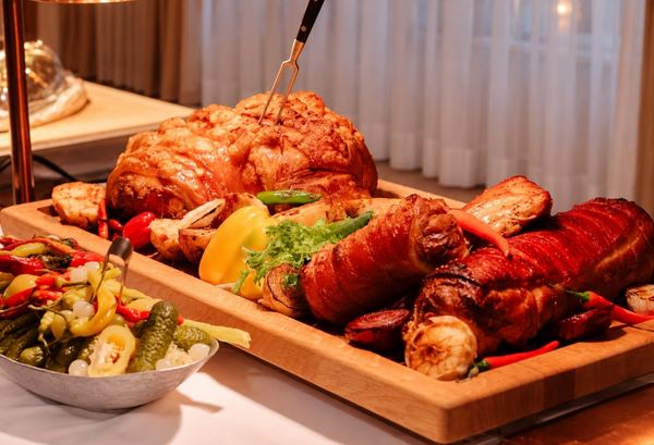 Roast pork and vegetables on a wooden board
