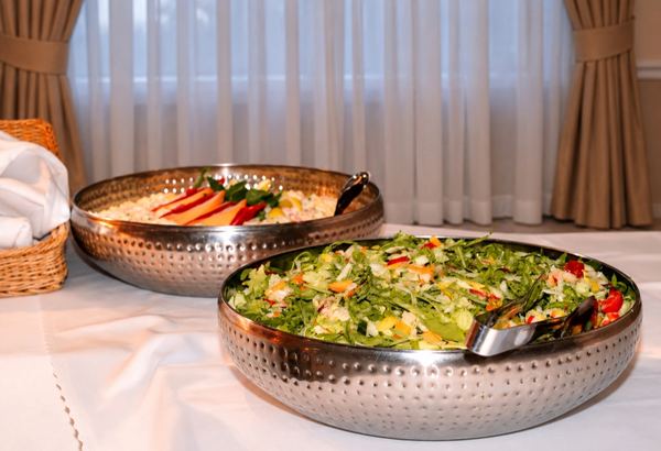 Salads in metal bowls on the buffet