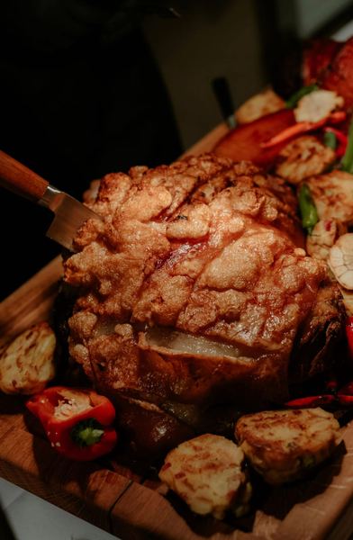 Roast meat with vegetables on a wooden board