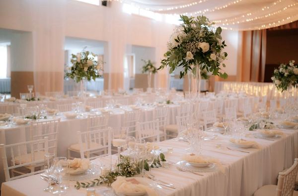 Wedding hall with laid tables and flowers